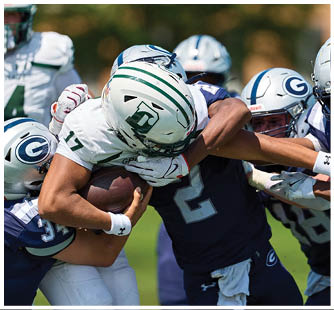 A football game is taking place with a group of men on the field. Description generated by AI