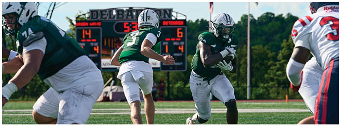 A football game is taking place with players on the field. Description generated by AI