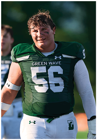 Two football players wearing blue and white uniforms. Description generated by AI