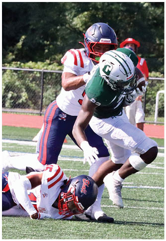 Two football players wearing blue and white uniforms. Description generated by AI