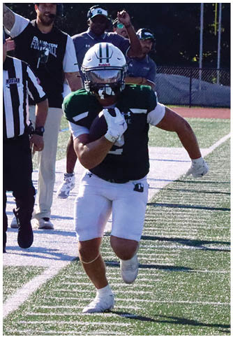 Two football players wearing blue and white uniforms. Description generated by AI