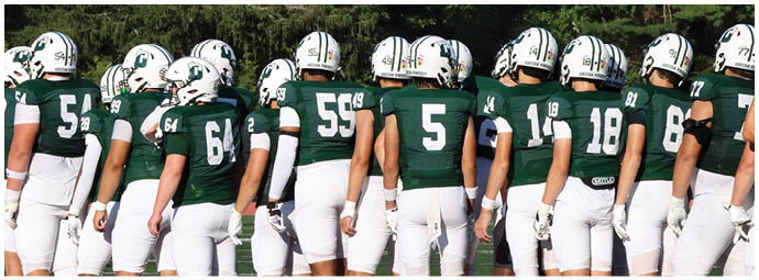 A football game is taking place with players on the field. Description generated by AI
