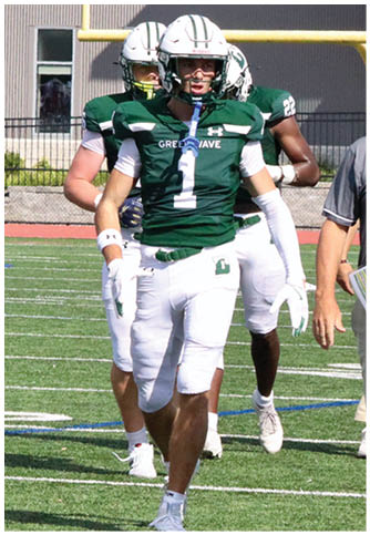 Two football players wearing blue and white uniforms. Description generated by AI