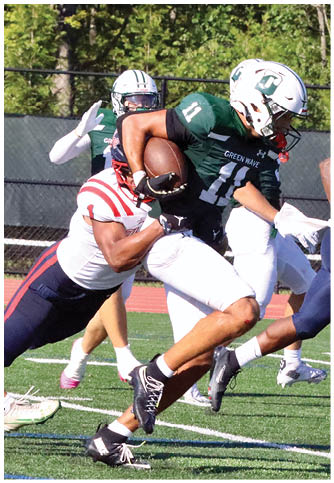 Two football players wearing blue and white uniforms. Description generated by AI