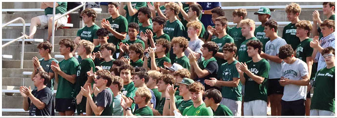 A group of people are sitting in the bleachers. Description generated by AI
