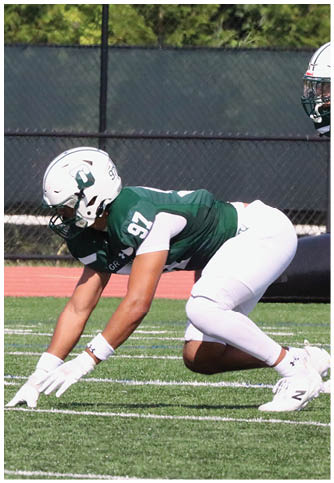 Two football players wearing blue and white uniforms. Description generated by AI