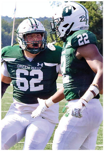 Two football players wearing blue and white uniforms. Description generated by AI