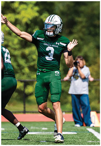 Two football players wearing blue and white uniforms. Description generated by AI