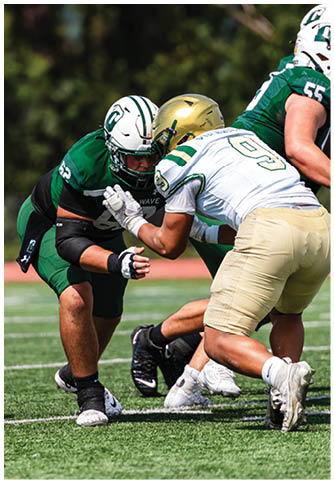 Two football players wearing blue and white uniforms. Description generated by AI