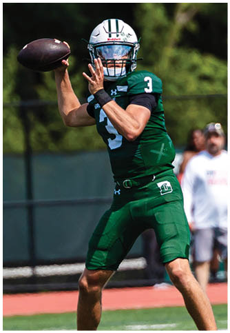 Two football players wearing blue and white uniforms. Description generated by AI
