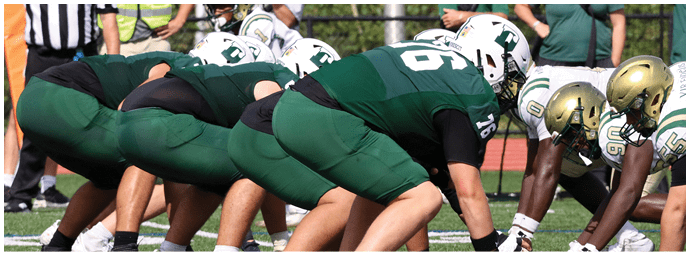 A football game is taking place with players on the field. Description generated by AI