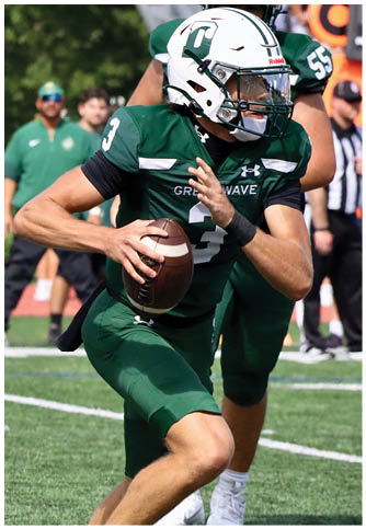 Two football players wearing blue and white uniforms. Description generated by AI