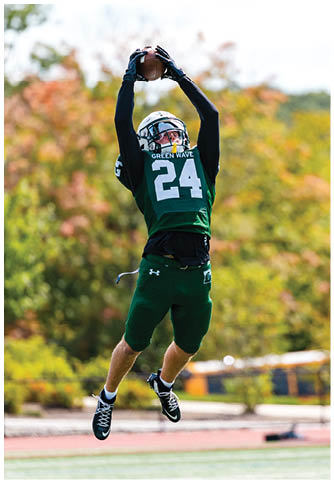 Two football players wearing blue and white uniforms. Description generated by AI