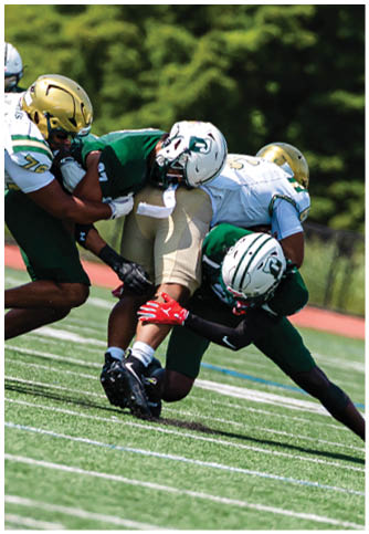 Two football players wearing blue and white uniforms. Description generated by AI