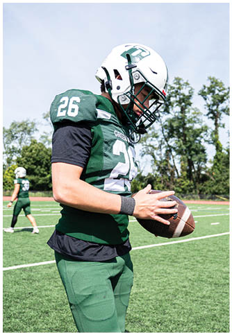 Two football players wearing blue and white uniforms. Description generated by AI