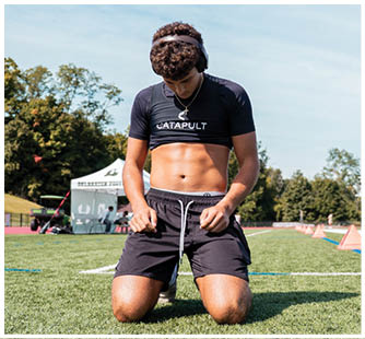 A football game is taking place with a group of men on the field. Description generated by AI