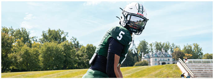 A football game is taking place with players on the field. Description generated by AI