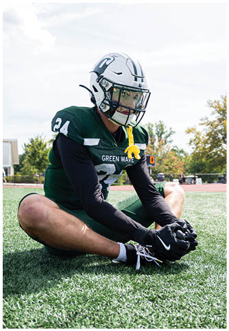 Two football players wearing blue and white uniforms. Description generated by AI
