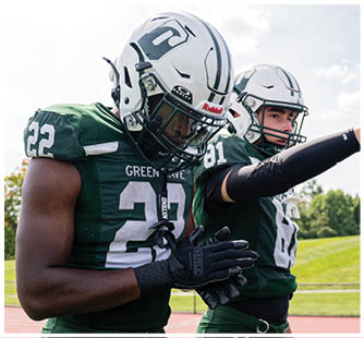 A football game is taking place with a group of men on the field. Description generated by AI