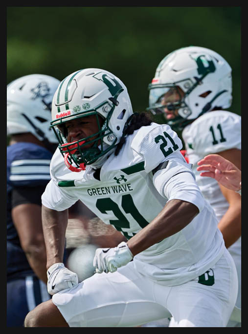 A football player in a white uniform is running with a football in his hand. AI generated content
