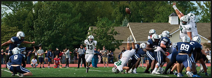 A football game is taking place with players on the field. Description generated by AI