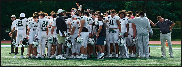 A football game is taking place with players on the field. Description generated by AI