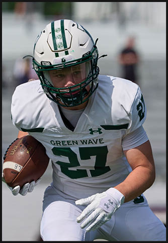 Two football players wearing blue and white uniforms. Description generated by AI