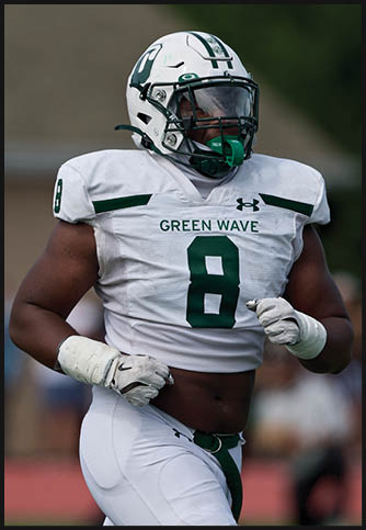Two football players wearing blue and white uniforms. Description generated by AI