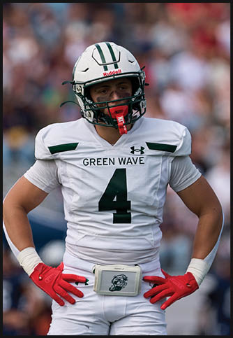 Two football players wearing blue and white uniforms. Description generated by AI