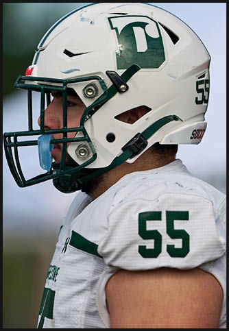 Two football players wearing blue and white uniforms. Description generated by AI