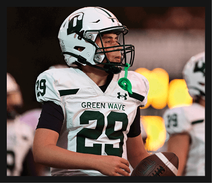 A man wearing a football uniform is jumping to catch a football. AI generated content