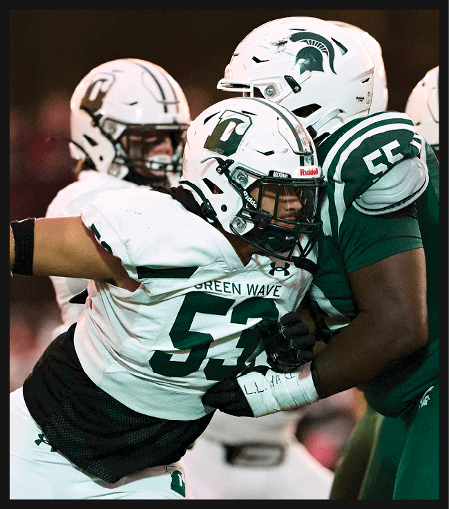A football game is in progress with players on the field. One player is throwing a football while another player is trying to catch it. The players are wearing uniforms and are actively engaged in the game. AI generated content