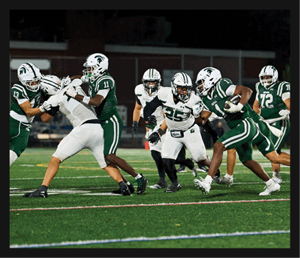 Two football players celebrating a touchdown with one player jumping in the air. AI generated content