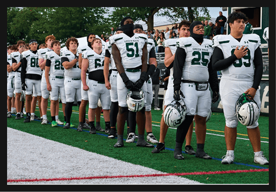 A group of football players wearing headphones and smiling. AI generated content