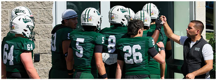 A group of football players on a field. Description generated by AI