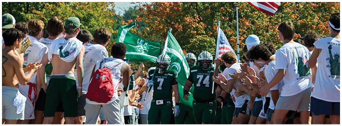 A group of football players on a field. Description generated by AI