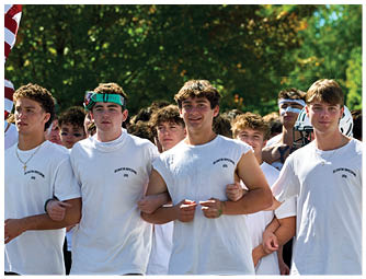 A group of football players on a field. Description generated by AI