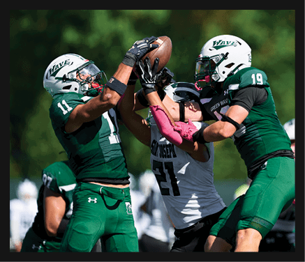 A man wearing a football uniform is jumping to catch a football. AI generated content