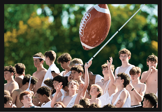 A group of people are kneeling on a field, possibly in a football game. AI generated content