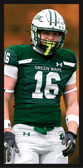 A football player is kneeling on the field, wearing a green jersey and a helmet. AI generated content