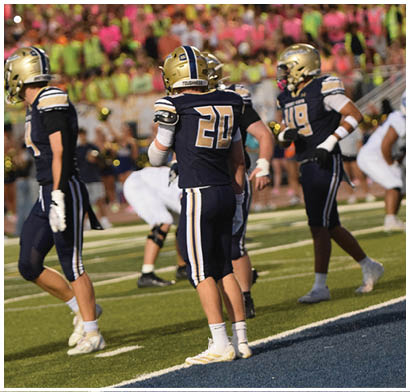 A group of football players in uniforms are standing on a field. AI generated content