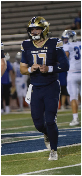 A football player in a blue uniform is walking on the field. AI generated content