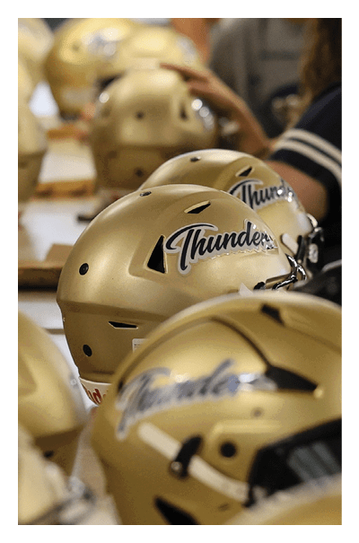 A table with several football helmets on it. AI generated content