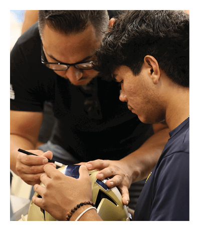 A man is signing a football helmet for a young man. AI generated content