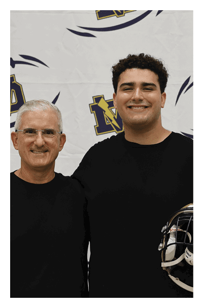 Two men are standing in front of a football banner, one of them holding a football helmet. AI generated content