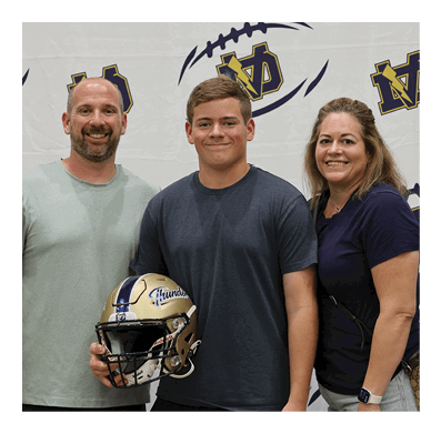 A man and two women pose for a photo with a football helmet. AI generated content