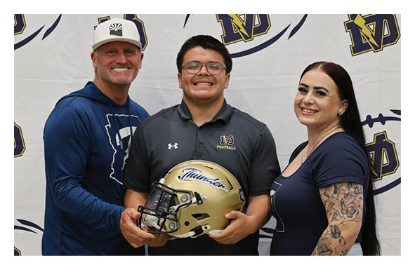 Three people pose with a football helmet, one of them wearing a blue shirt. AI generated content