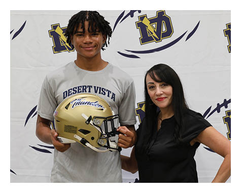 A man and a woman pose for a photo with a football helmet. AI generated content