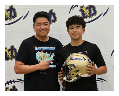 A man and a boy are standing in front of a football. AI generated content