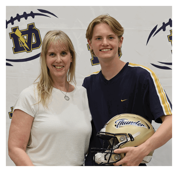 A man and woman pose with a football helmet. AI generated content